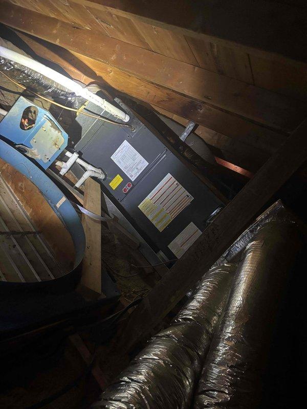 Completed monthly recurring cooling maintenance visit under Basic Plus service plan. Inspected outdoor condenser unit which showed significant accumulation of dirt, dust, and debris on coil fins and grilles, particularly concentrated in upper and middle sections. Assessed indoor air handler unit located in attic space and verified operational status of system components. Replaced 20x20x4 air filter as part of routine maintenance protocol. Documented equipment condition through photographic records showing outdoor unit contamination and indoor air handler installation with associated ductwork and plumbing connections.