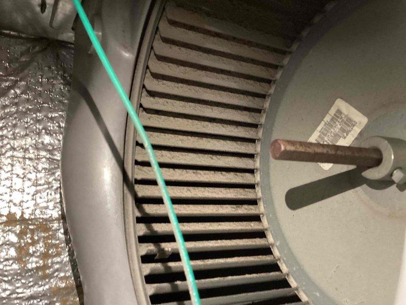 # HVAC Cooling System Maintenance Completed

Performed comprehensive AC tune-up on York HVAC system located in basement utility area. Conducted thorough inspection of furnace unit, air handler cabinet, and associated ductwork connections. Evaluated blower wheel assembly and noted dust and debris accumulation on squirrel cage fan blades affecting airflow efficiency.

Cleaned blower wheel components to restore optimal air circulation and system performance. Inspected metallic flexible ductwork connections and verified proper sealing at furnace plenum. Checked all visible mounting hardware, brackets, and equipment housing for secure installation. Examined refrigerant lines and electrical connections running through the system.

Verified manufacturer specifications on equipment labels and confirmed system operational parameters. Tested blower motor function and assessed overall equipment condition. All components evaluated for wear and proper operation. System restored to efficient operati