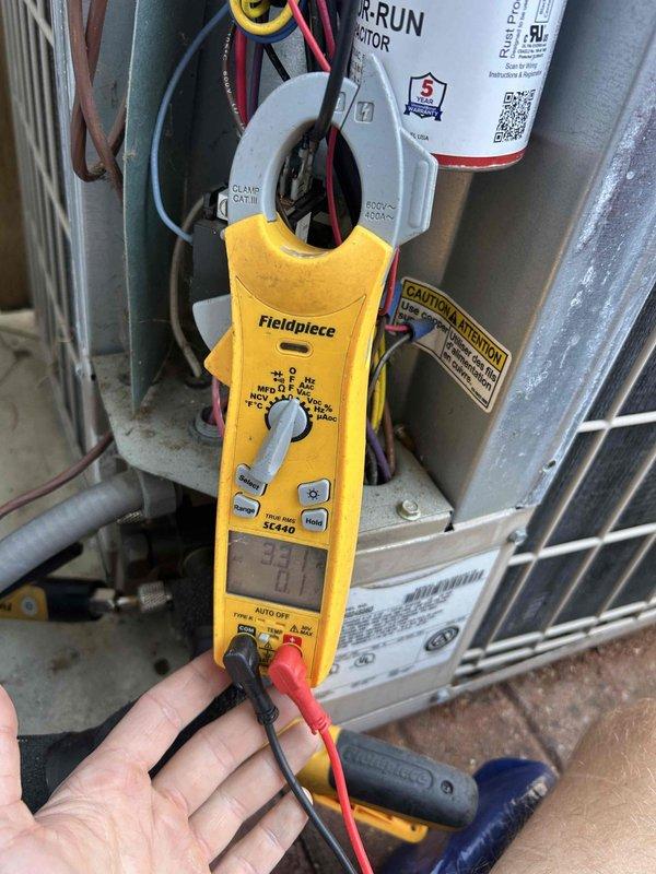Responded to no-cooling complaint on 11-year-old air conditioning system where outdoor compressor unit had stopped operating. Upon arrival, performed diagnostic testing on condenser unit using clamp meter to measure electrical values at capacitor and compressor terminals. Identified failed run capacitor preventing compressor from starting. Replaced defective capacitor with new unit, verified proper voltage and amperage readings, and confirmed compressor operation restored. System tested and operating normally with proper cooling cycle.
