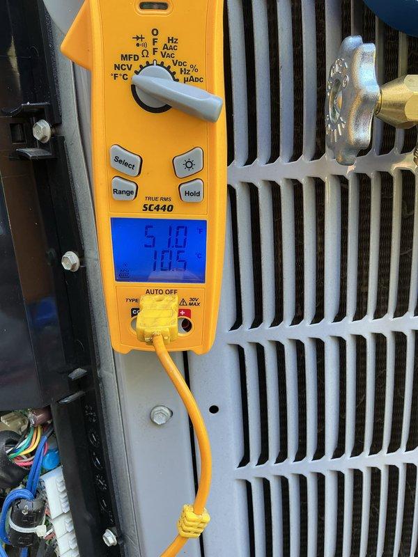 Completed basic monthly cooling maintenance visit on HVAC system. Performed electrical diagnostics using digital multimeter, measuring voltage and capacitance readings on system components to verify proper operation. All electrical parameters tested within normal operating ranges at 105V and 5.10 reading on capacitor circuit. Inspected A.O. Smith water heater with circulation pump assembly as part of combined heating and cooling system evaluation. Verified all equipment operating properly with no issues identified during routine preventive maintenance inspection.