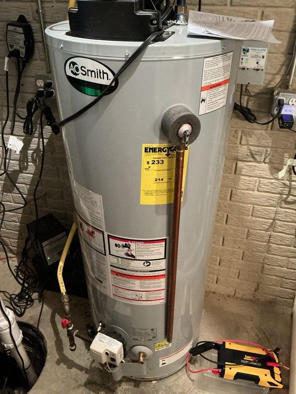 Completed basic monthly cooling maintenance visit on HVAC system. Performed electrical diagnostics using digital multimeter, measuring voltage and capacitance readings on system components to verify proper operation. All electrical parameters tested within normal operating ranges at 105V and 5.10 reading on capacitor circuit. Inspected A.O. Smith water heater with circulation pump assembly as part of combined heating and cooling system evaluation. Verified all equipment operating properly with no issues identified during routine preventive maintenance inspection.