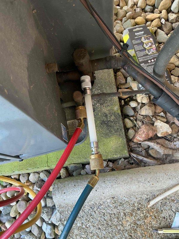 Responded to service call for frozen air conditioning unit on 11-year-old system. Upon arrival, connected manifold gauges to assess refrigerant pressures and system operation. Identified severely corroded copper refrigerant lines and weathered connections at outdoor condenser unit, contributing to restricted airflow and freeze-up condition. Inspected indoor Heil furnace and evaporator coil assembly for ice accumulation and airflow restrictions. Thawed frozen evaporator coil, verified proper drainage, and assessed overall system performance to restore cooling operation.