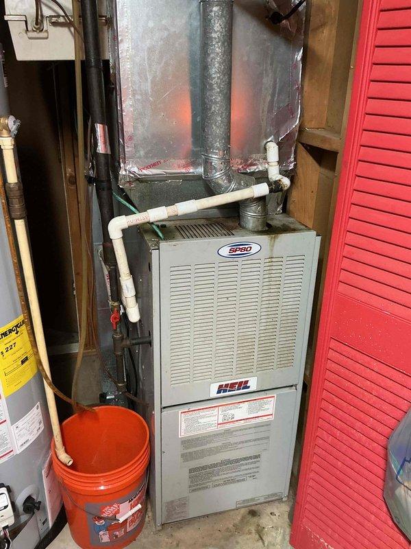 Responded to service call for frozen air conditioning unit on 11-year-old system. Upon arrival, connected manifold gauges to assess refrigerant pressures and system operation. Identified severely corroded copper refrigerant lines and weathered connections at outdoor condenser unit, contributing to restricted airflow and freeze-up condition. Inspected indoor Heil furnace and evaporator coil assembly for ice accumulation and airflow restrictions. Thawed frozen evaporator coil, verified proper drainage, and assessed overall system performance to restore cooling operation.