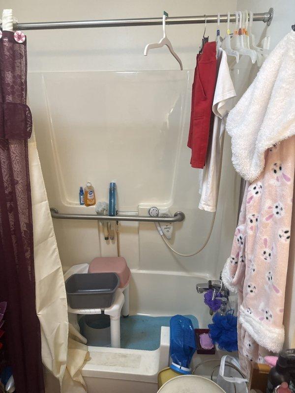 Conducted on-site assessment at assisted living facility to provide separate estimates for walk-in shower installations in two residential units, Apartment 23 and Apartment 27. Evaluated existing bathroom configurations, noting current tub-shower combinations with accessibility features including grab bars, shower benches, and handheld showerheads. Documented measurements and existing plumbing rough-in locations to determine scope of work required for converting standard tub units to barrier-free walk-in shower systems suitable for elderly residents with mobility considerations.