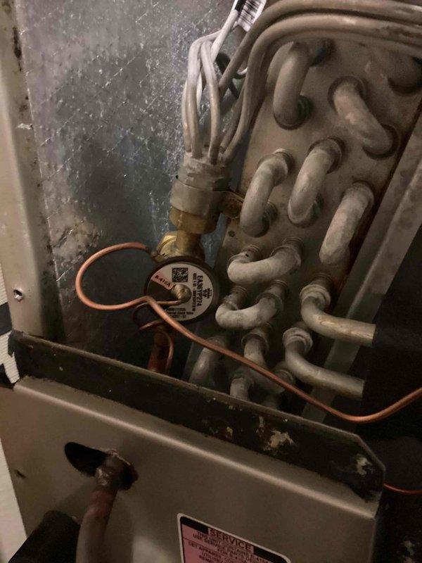 Returned to site to replace faulty thermostatic expansion valve (TXV) on residential HVAC system. Accessed evaporator coil assembly, removed defective TXV, and installed new brass expansion valve with proper refrigerant line connections. Evacuated system, recharged with refrigerant to manufacturer specifications, and verified proper operating pressures and temperatures using manifold gauges to ensure optimal system performance.