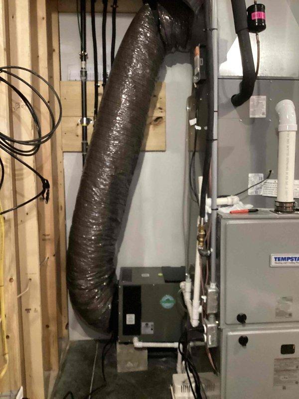 Returned to property to complete installation of whole home dehumidifier unit in mechanical room. Successfully installed Tempstar dehumidifier with all necessary ductwork connections, including flexible black supply duct integrated into existing HVAC system. Completed all electrical connections, installed condensate pump for drainage, ran PVC drain lines, and secured all refrigerant lines and wiring per manufacturer specifications. Unit tested and operational, providing proper humidity control for the entire home.