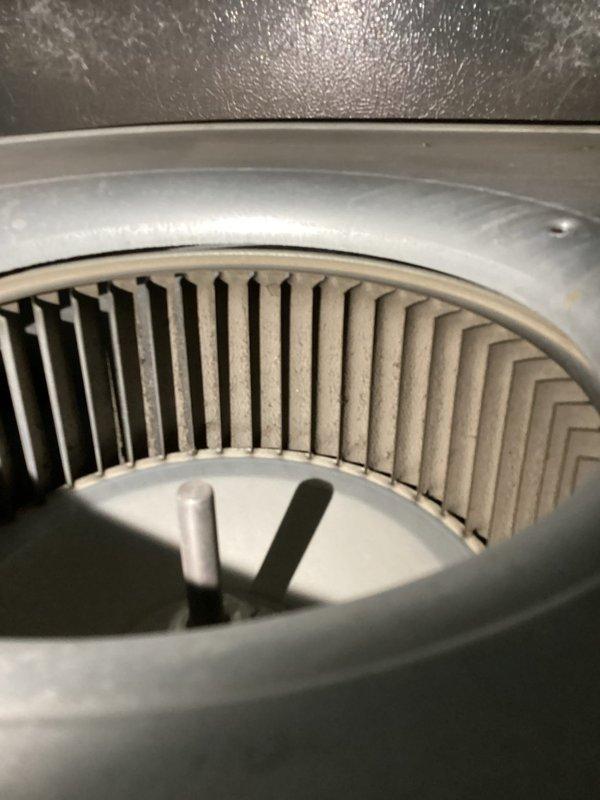 Responded to customer complaint regarding excessive humidity despite dehumidification mode operation. Upon inspection, found significant dust accumulation on blower wheel affecting airflow efficiency. Thermostat confirmed system operating in cooling mode with indoor temperature at 70°F and humidity reading at 58%, which is elevated for proper comfort levels. Documented blower assembly condition and thermostat settings for service records and recommended cleaning of blower wheel to restore proper air circulation and improve dehumidification performance.