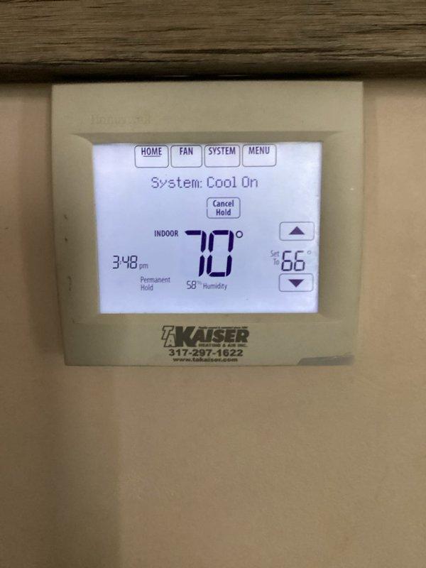 Responded to customer complaint regarding excessive humidity despite dehumidification mode operation. Upon inspection, found significant dust accumulation on blower wheel affecting airflow efficiency. Thermostat confirmed system operating in cooling mode with indoor temperature at 70°F and humidity reading at 58%, which is elevated for proper comfort levels. Documented blower assembly condition and thermostat settings for service records and recommended cleaning of blower wheel to restore proper air circulation and improve dehumidification performance.
