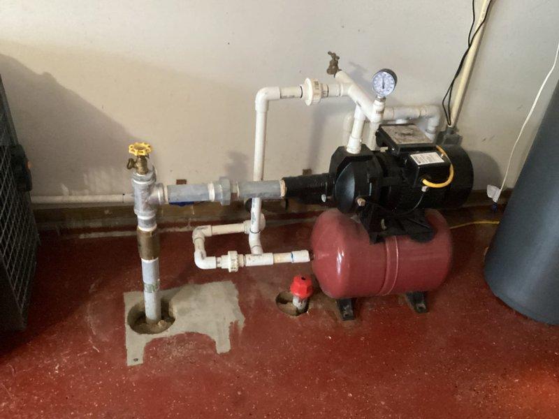 Completed annual plumbing inspection of residential property. Inspected and documented pressure tank system with pump assembly, including verification of pressure gauge operation, PVC piping connections, and shut-off valve functionality. Examined under-sink plumbing configuration, confirming proper P-trap installation and drain assembly integrity. All components found to be in satisfactory operating condition with no leaks detected at time of inspection.