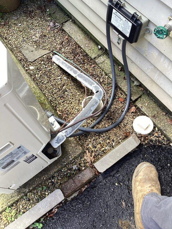 Completed annual plumbing inspection of residential property, examining all accessible water supply lines, shut-off valves, and connection points. Documented current condition of plumbing fixtures including chrome-plated flexible supply lines with blue-handled shut-off valves, noting water staining on wooden mounting panel that indicates previous moisture exposure but no active leaks present at time of inspection. All photographed components found operational and functioning within normal parameters.