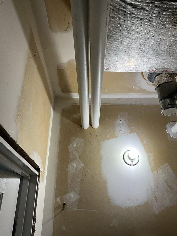 Conducted comprehensive cooling system evaluation and replacement consultation for 16-year-old operational air conditioning system. Assessed severely rusted evaporator coil requiring attention and documented existing Carrier equipment configuration with associated ductwork and drainage components. Provided equipment replacement pricing options and confirmed scheduled auxiliary work including garage supply vent sealing modification and condensate pump installation at outdoor unit location.