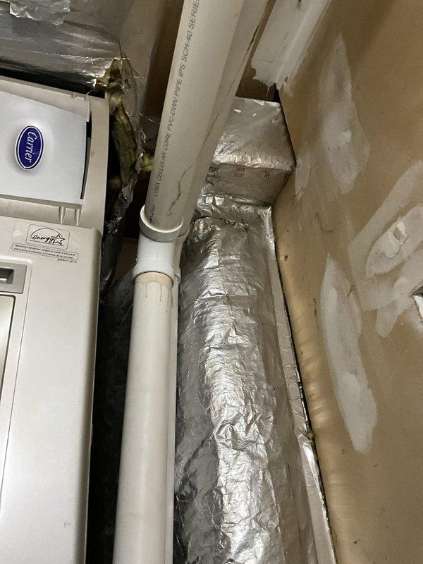 Conducted comprehensive cooling system evaluation and replacement consultation for 16-year-old operational air conditioning system. Assessed severely rusted evaporator coil requiring attention and documented existing Carrier equipment configuration with associated ductwork and drainage components. Provided equipment replacement pricing options and confirmed scheduled auxiliary work including garage supply vent sealing modification and condensate pump installation at outdoor unit location.