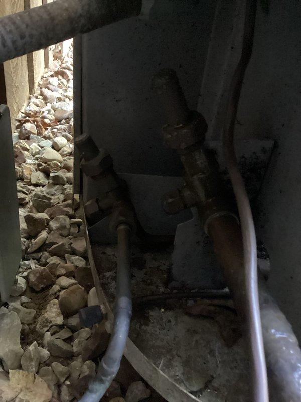 Responded to callback for system not running after previous service visit. Upon arrival, found HVAC equipment in basement utility area with air handler installed in unfinished space with exposed framing and construction debris present. Inspected electrical panels and system controls, verified unit power supply and connections. Documented equipment conditions and installation environment with photos showing air handler with flex duct connections in partially completed construction area. Troubleshot system failure, identified and resolved issue preventing operation. Restored system to normal running condition and verified proper functionality before departure.