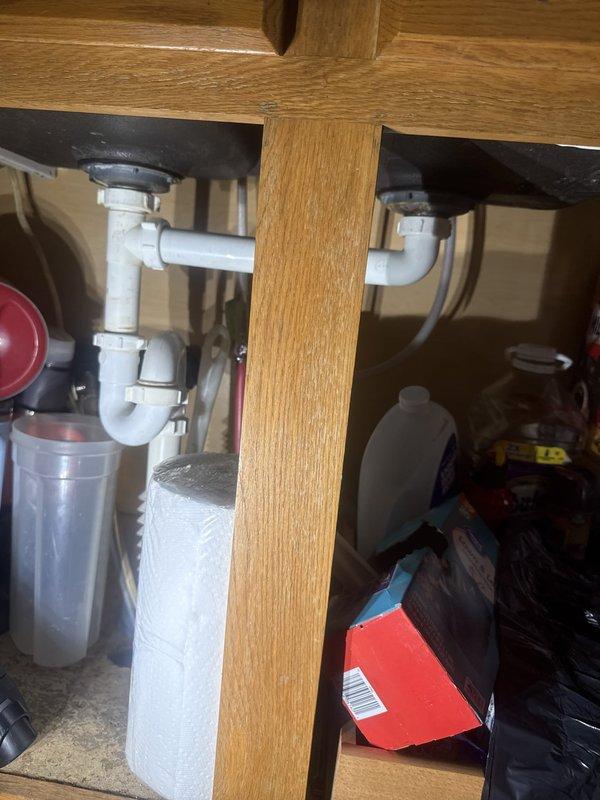 Completed monthly recurring plumbing inspection of residential property. Performed thorough visual examination of kitchen sink drain system, including dual P-traps and PVC waste lines beneath cabinet, confirming proper drainage configuration and absence of leaks. Conducted crawl space inspection, evaluating main drain line condition, support structure integrity, and verifying no signs of active water intrusion or pipe deterioration. All plumbing systems observed operating within normal parameters with no immediate repairs required. Photographic documentation captured for maintenance records.