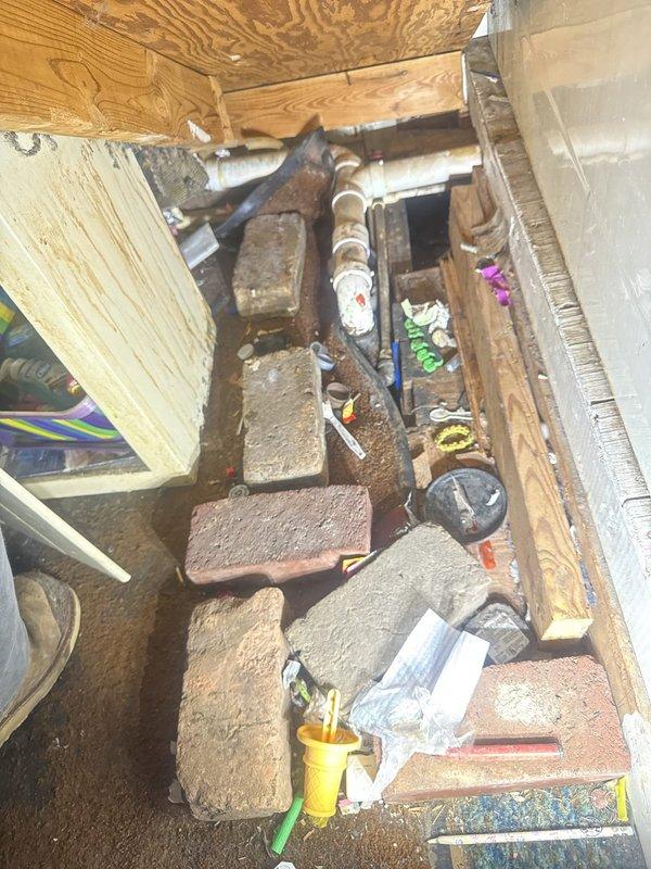 Completed monthly recurring plumbing inspection of residential property. Performed thorough visual examination of kitchen sink drain system, including dual P-traps and PVC waste lines beneath cabinet, confirming proper drainage configuration and absence of leaks. Conducted crawl space inspection, evaluating main drain line condition, support structure integrity, and verifying no signs of active water intrusion or pipe deterioration. All plumbing systems observed operating within normal parameters with no immediate repairs required. Photographic documentation captured for maintenance records.