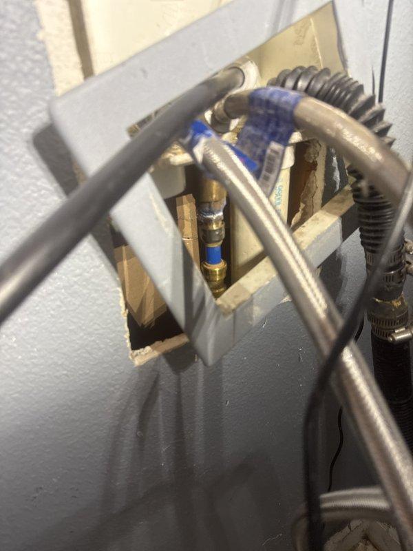 Responded to service call for non-functioning shut-off valve due to severe rust and corrosion preventing proper operation. Upon inspection, found existing valve had deteriorated beyond repair and required replacement to restore proper water control functionality. Documented existing plumbing configuration showing corroded valve assembly, flexible supply lines, and access panel installation for future reference.