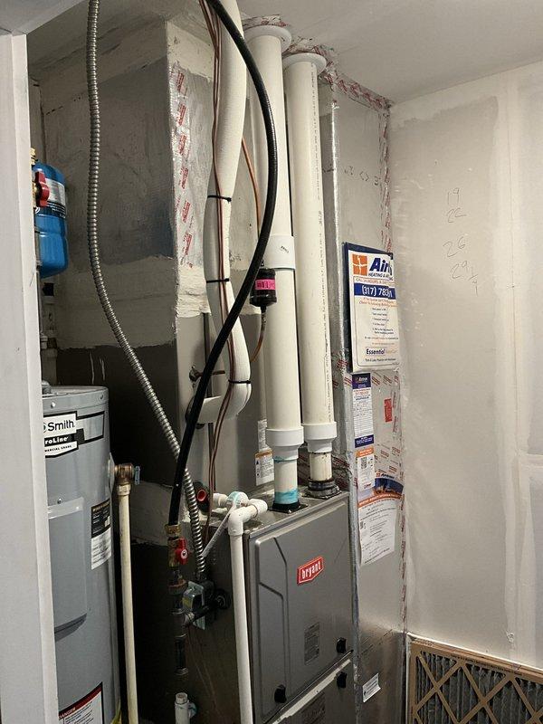 Conducted on-site assessment for installation of whole-home dehumidifier and humidifier system to improve indoor air quality. Evaluated existing HVAC infrastructure including Bryant furnace unit, reviewed available installation locations in utility area near water heater and main plumbing chase, and documented current mechanical room configuration with PVC drainage routing and electrical service access points for equipment integration.