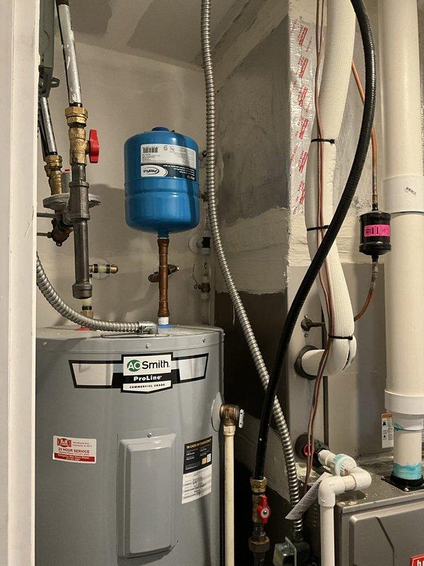 Conducted on-site assessment for installation of whole-home dehumidifier and humidifier system to improve indoor air quality. Evaluated existing HVAC infrastructure including Bryant furnace unit, reviewed available installation locations in utility area near water heater and main plumbing chase, and documented current mechanical room configuration with PVC drainage routing and electrical service access points for equipment integration.
