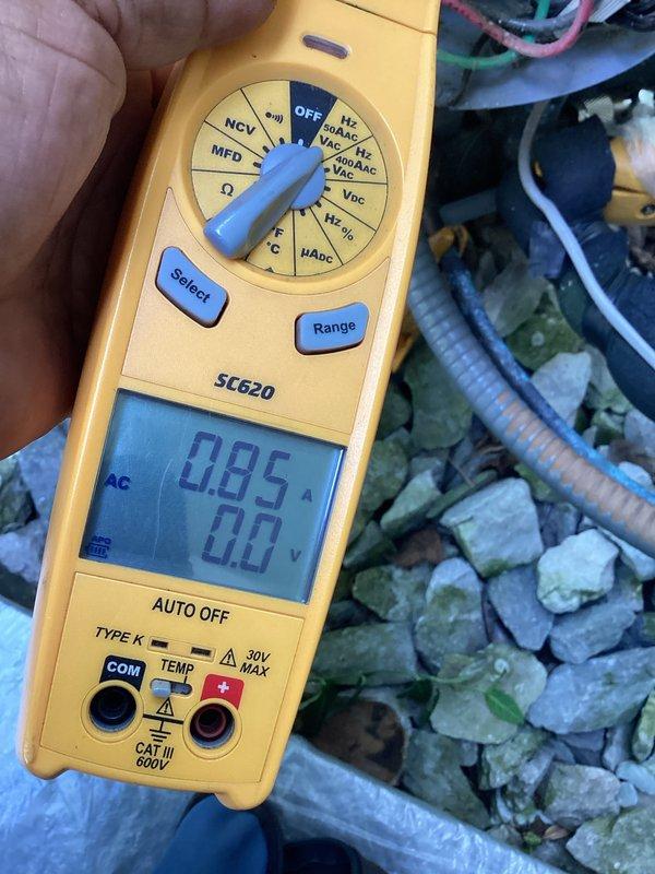 Responded to callback for non-operational HVAC system. Upon arrival, performed electrical diagnostics using digital multimeter to measure amperage and voltage at outdoor unit components. Readings indicated 0.85A draw with minimal voltage present. Inspected control board, capacitors, contactor, and associated wiring connections within outdoor condensing unit. Documented equipment condition and electrical measurements with photos for service records. System required further troubleshooting to identify root cause of repeated failure following previous service visit.