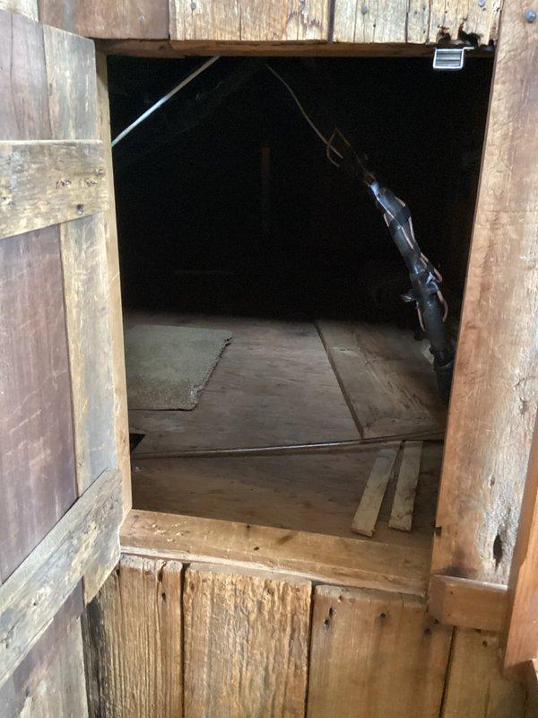 Accessed attic space through staircase entry hatch to service mini split head unit. Applied silicone sealant to drain line connections to prevent condensate leakage. Verified proper drainage operation and secured all components before closing access point.