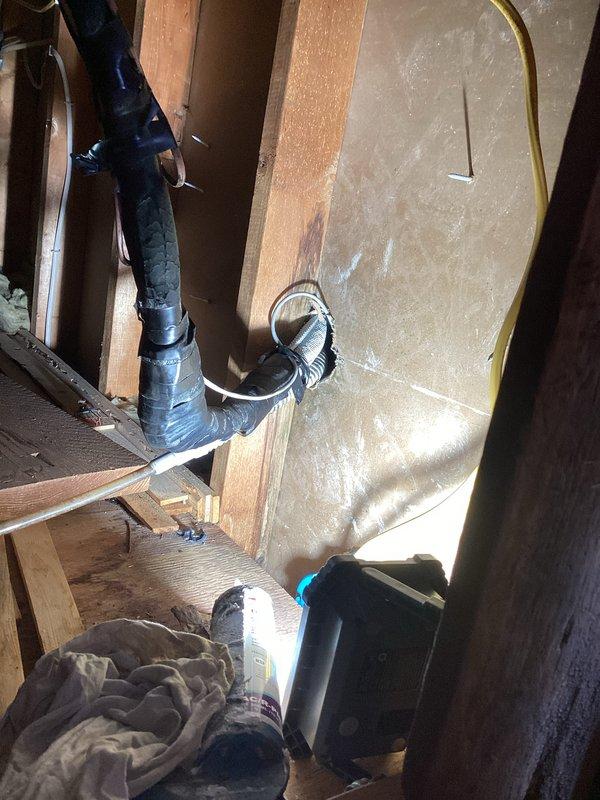 Accessed attic space through staircase entry hatch to service mini split head unit. Applied silicone sealant to drain line connections to prevent condensate leakage. Verified proper drainage operation and secured all components before closing access point.