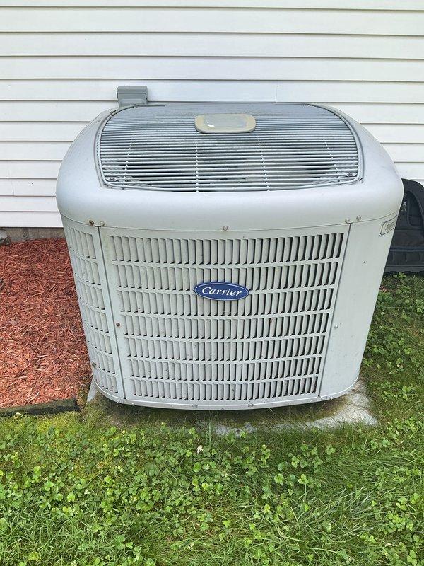 Completed scheduled heating maintenance tune-up on 16-year-old Carrier system. Performed comprehensive inspection of indoor evaporator coil assembly, noting visible dust accumulation between fins and minor debris buildup in drain pan area. Inspected outdoor condensing unit, confirming proper placement on concrete pad with adequate clearance from structure. Unit showed normal weathering for age with all components operational. Verified system readiness for heating season per manufacturer maintenance specifications.
