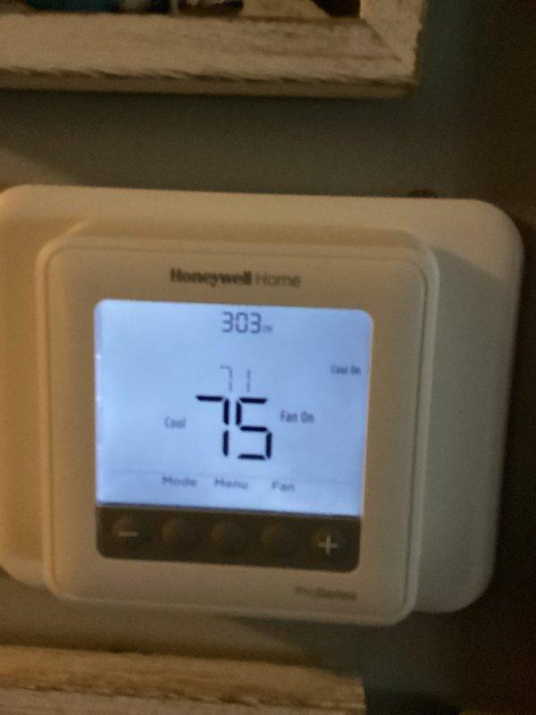 Responded to callback for non-operational HVAC system following recent maintenance visit where capacitor was replaced. Upon arrival, verified thermostat settings and confirmed system status, observing display showing 71° current temperature with cooling setpoint of 75° and fan operation active. Documented equipment conditions for service records.