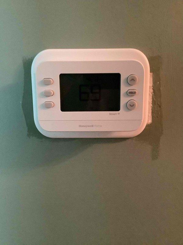 Completed installation of Goodman gas/AC package unit with proper insulation, wire routing, and sealing at all panel connections. Installed and programmed Honeywell Home Smart thermostat for system control and operation.
