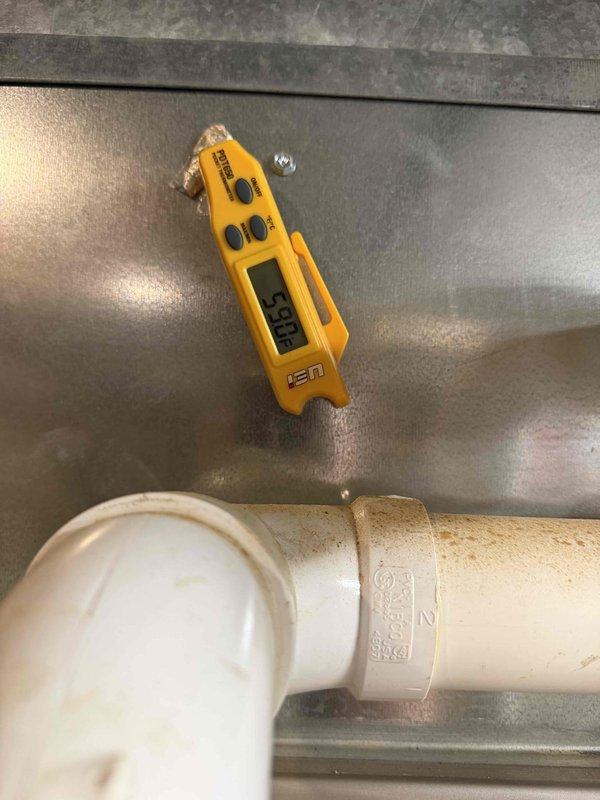 Returned to property and successfully replaced the BLU tube UV bulb in the HVAC system. Verified proper operation with temperature readings showing 158°F at the ductwork, confirming system functionality after bulb replacement.