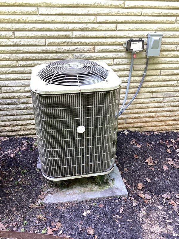 Responded to no-cooling call on residential air conditioning system. Upon arrival, performed diagnostic evaluation of outdoor condenser unit and indoor thermostat controls. Thermostat displayed active cooling mode with setpoint at 73 degrees while ambient temperature read 75 degrees, indicating system was calling for cooling but not achieving desired temperature. Inspected outdoor condenser unit positioned on concrete pad with electrical disconnect box and confirmed unit was not operating. Conducted electrical testing at disconnect and verified power supply to unit. Diagnosed failed capacitor preventing compressor and condenser fan motor from starting. Replaced dual-run capacitor with proper MFD-rated component. Tested system operation and confirmed compressor engagement and condenser fan rotation. Verified proper amp draw on both compressor and fan motor. System cycled properly and began producing cold air at supply registers. Documented equipment condition with photographs of outdoor