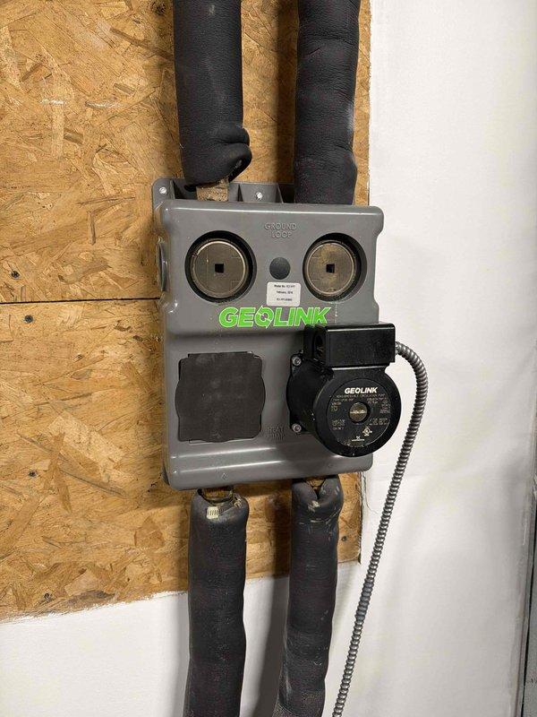 Responded to callback for GEOLINK geothermal system displaying "SERVICE NEEDED" and "SYSTEM LOCKOUT" error on thermostat. Upon inspection, identified fault condition triggering safety lockout on ground loop control unit. Cleared error codes, verified ground loop circulation pump operation, checked refrigerant line connections and insulation integrity on all four ground loop pipes. Reset system lockout at thermostat, confirmed proper communication between control unit and thermostat, and verified system returned to normal heating/cooling operation without further fault codes.