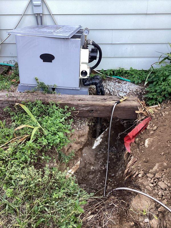 Responded to potential refrigerant leak concern on HVAC system. Excavated and exposed underground refrigerant lines to inspect for leak points, revealing piping runs and connections near exterior equipment location. Documented exposed lineset and utility connections for further diagnostic evaluation and repair planning.