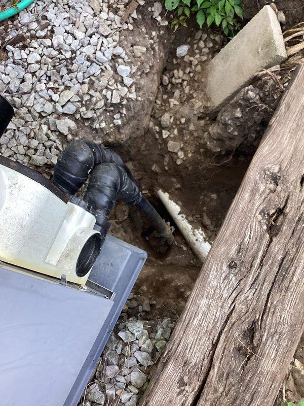 Responded to potential refrigerant leak concern on HVAC system. Excavated and exposed underground refrigerant lines to inspect for leak points, revealing piping runs and connections near exterior equipment location. Documented exposed lineset and utility connections for further diagnostic evaluation and repair planning.