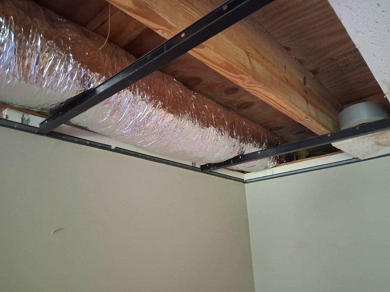 Completed ductwork renovation by removing existing metal duct system and installing 9 feet of 6-inch flexible duct in ceiling space. Secured new flex duct between structural joists with proper support and insulation, ensuring adequate airflow through the modified HVAC distribution system.