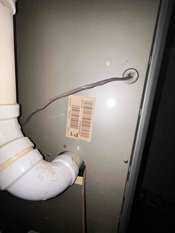 Responded to service call for non-operational outdoor air conditioning unit. Upon arrival, performed diagnostic inspection of condenser unit and associated components. Inspected condenser coils, electrical connections, refrigerant lines, and condensate drainage system. Documented equipment condition including protective grille, access panels, and PVC condensate piping with proper drainage connections. Unit evaluated and photographed for service records.