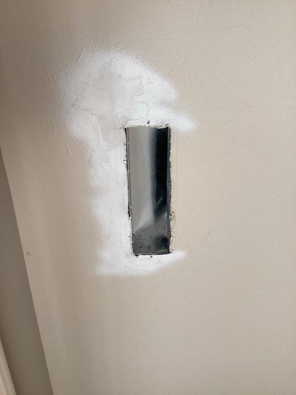 Responded to service call for reported ductwork leakage issues. Upon inspection, located compromised section of ductwork requiring access through wall cavity. Created access opening to assess duct system connected to vertical air handler unit. Identified leak source at duct connection points and documented system configuration including supply/return air distribution, refrigerant lines, and condensate drainage system for repair recommendations.