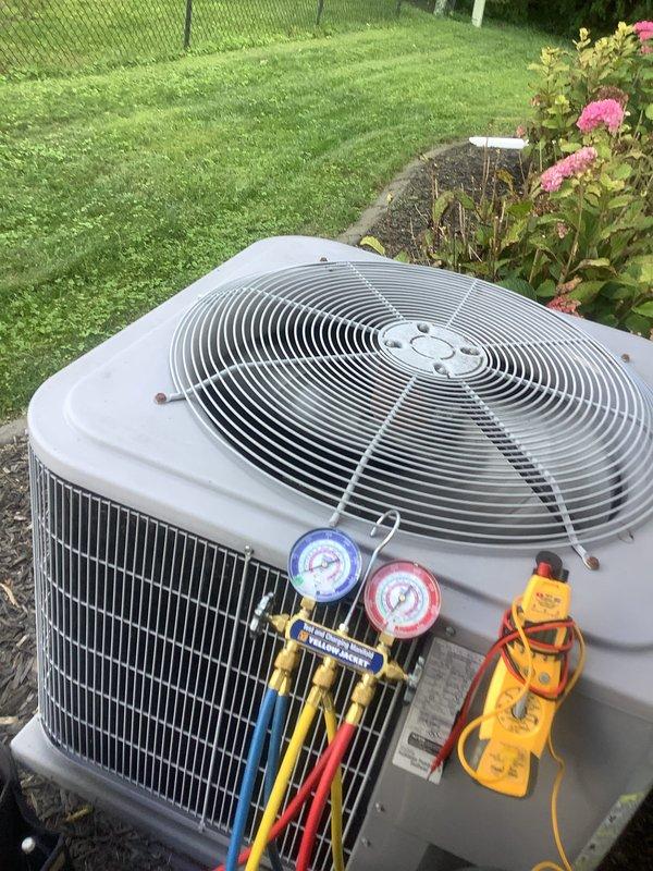 Completed comprehensive maintenance service on residential split HVAC system including both indoor furnace unit and outdoor condensing unit. Performed standard heating and cooling system inspection in basement utility area, checking furnace operation, PVC condensate drainage, and air handler components. Proceeded to outdoor unit where refrigerant pressures were measured and recorded using manifold gauge set, verifying system charge levels and operational parameters. Conducted electrical diagnostics with digital multimeter to ensure proper voltage and amperage readings across system components. All equipment found operating within manufacturer specifications with no deficiencies noted requiring immediate correction.