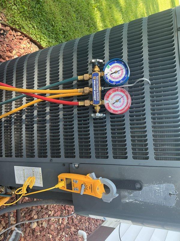 Completed basic monthly heating maintenance visit on residential HVAC system. Performed standard system diagnostics using manifold gauges to verify refrigerant pressures and electrical testing equipment to check amperage draw on outdoor condenser unit. Thermostat operation confirmed with ProSeries Honeywell digital control displaying proper temperature readings and functional heating mode settings.