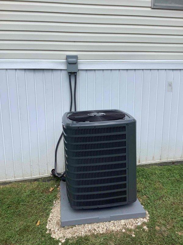 Completed full HVAC system replacement in mobile home, installing new air conditioning condenser unit and gas furnace. New outdoor condensing unit was positioned on concrete pad with proper gravel base for drainage and airflow, secured electrical conduit connection to structure, and verified all refrigerant line connections. Performed system commissioning using digital manifold gauges to confirm proper refrigerant charge levels and system pressures, ensuring optimal performance of the complete heating and cooling system.