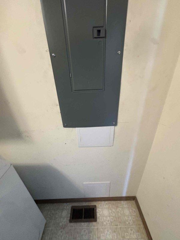 Returned to residence to complete warranty work on electrical panel installation. Coordinated utility disconnect between 9-10am to safely pull meter and correct panel wiring, with power restoration completed within one hour. Repaired drywall with access cover installation and reconfigured Lennox digital thermostat to proper operating parameters, with system verified operational and inspection passed at 11am.