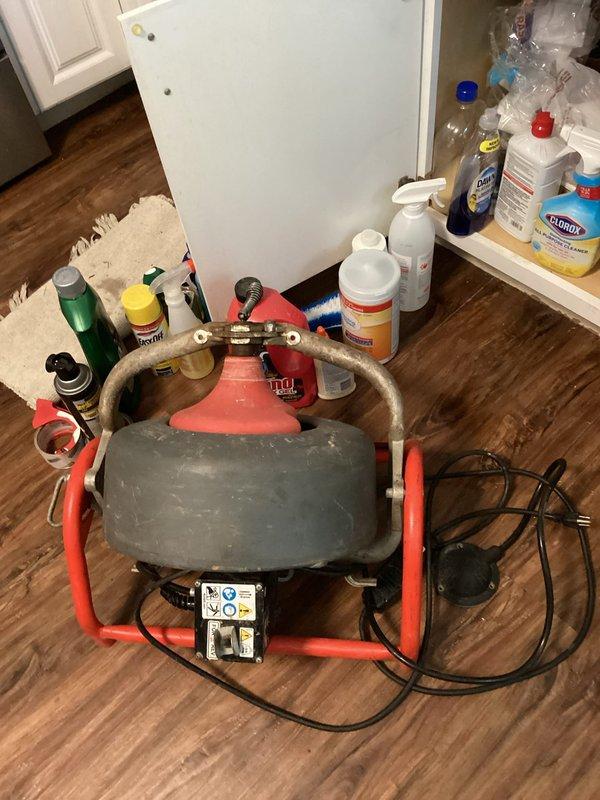 Responded to laundry room drain backup and flooding issue. Deployed drum-style drain cleaning machine to clear blockage in laundry room drainage system. Inspected under-sink plumbing connections and P-trap assembly to assess drainage flow and verify proper operation of waste lines following clearing procedure.