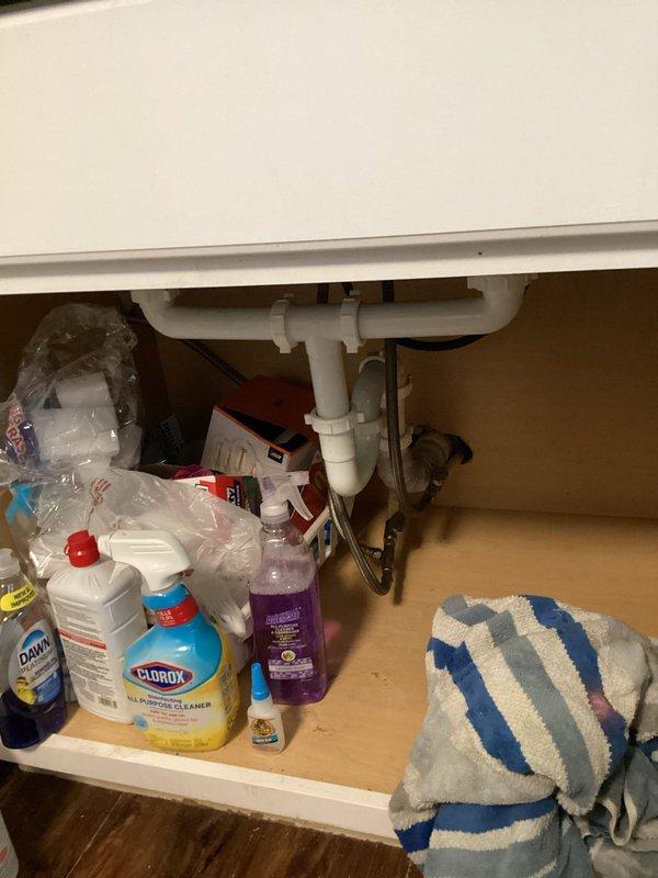 Responded to laundry room drain backup and flooding issue. Deployed drum-style drain cleaning machine to clear blockage in laundry room drainage system. Inspected under-sink plumbing connections and P-trap assembly to assess drainage flow and verify proper operation of waste lines following clearing procedure.