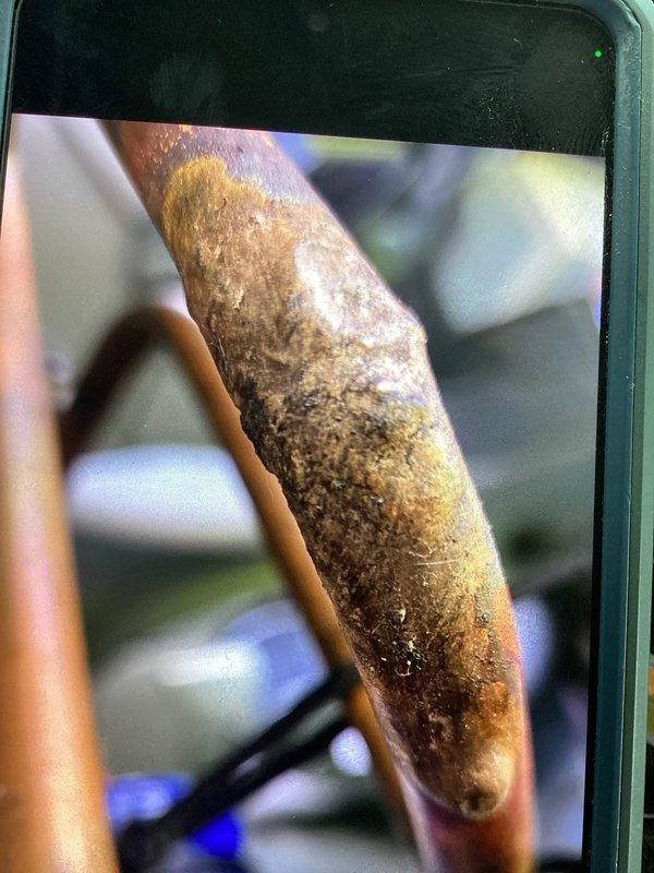 Responded to refrigerant leak on copper line set. Upon inspection, discovered severely corroded copper piping with extensive oxidation, pitting, and structural deterioration that had caused a complete failure of the refrigerant line. Performed braze repair to restore system integrity, replaced damaged section of copper tubing, pressure tested the repair, and recharged the system with refrigerant to manufacturer specifications.