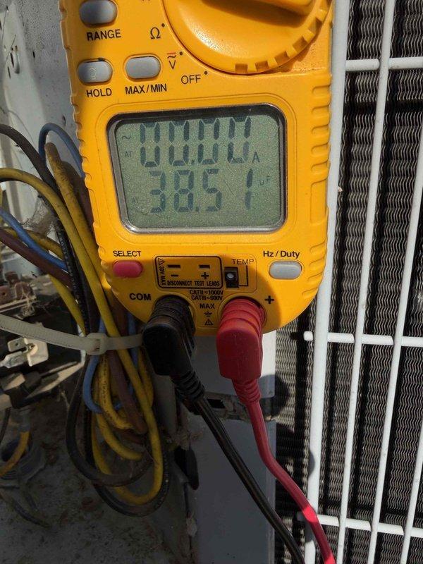 Responded to service call for air conditioning system with outdoor fan running but no cooling and thermostat operational issues. Upon arrival, performed diagnostic testing of the outdoor condensing unit using digital multimeter to verify electrical supply and component functionality, measuring voltage at 385V. Inspected condenser unit exterior condition, refrigerant line connections, and electrical conduit routing. Based on customer report that thermostat would not stay on and visual inspection findings, determined thermostat malfunction was preventing proper system operation and cooling cycle initiation.