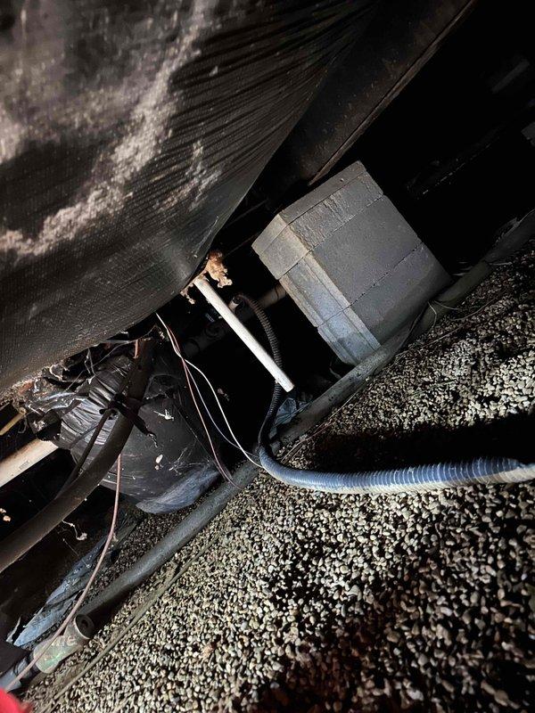 Responded to service call for leaking condensate drain line in crawlspace causing excessive moisture and odor issues throughout the residence. Upon inspection, discovered the condensate tube from the air conditioning system installed three years prior was actively leaking, creating constant dampness in the crawlspace with visible moisture accumulation on ductwork and surrounding surfaces. Documented existing conditions including significant dust buildup, crystalline deposits on HVAC components, and moisture damage to crawlspace area. Addressed the condensate drainage issue to eliminate ongoing water intrusion and prevent further moisture-related problems and odors in the living space.
