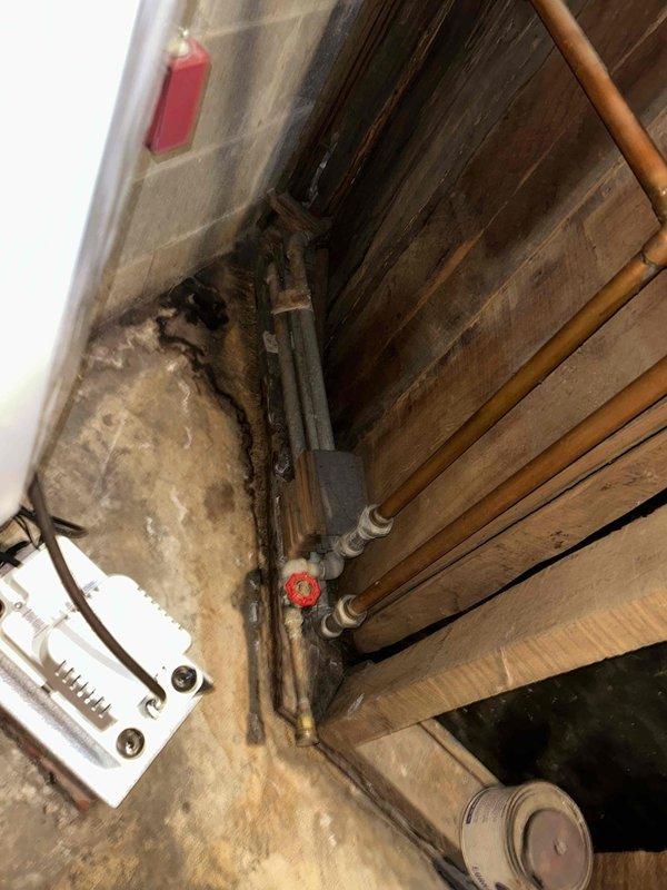 Performed comprehensive boiler maintenance and inspected hydronic heating system for reported leak. Thoroughly examined dual circulator pump assembly, copper piping loop configuration, and all soldered joints throughout the system. Identified moisture concerns in mechanical room with visible floor staining and efflorescence on concrete surface, inspected all pipe connections, valve assemblies, and flexible connectors for signs of active leakage. Documented condition of circulator pumps with control dials, bypass piping arrangement, and shut-off valves. Assessed aged plumbing installation including copper pipe oxidation patterns and all fittings in utility space. System operational at time of inspection; recommended monitoring for active leak source and potential follow-up for identified moisture issues.