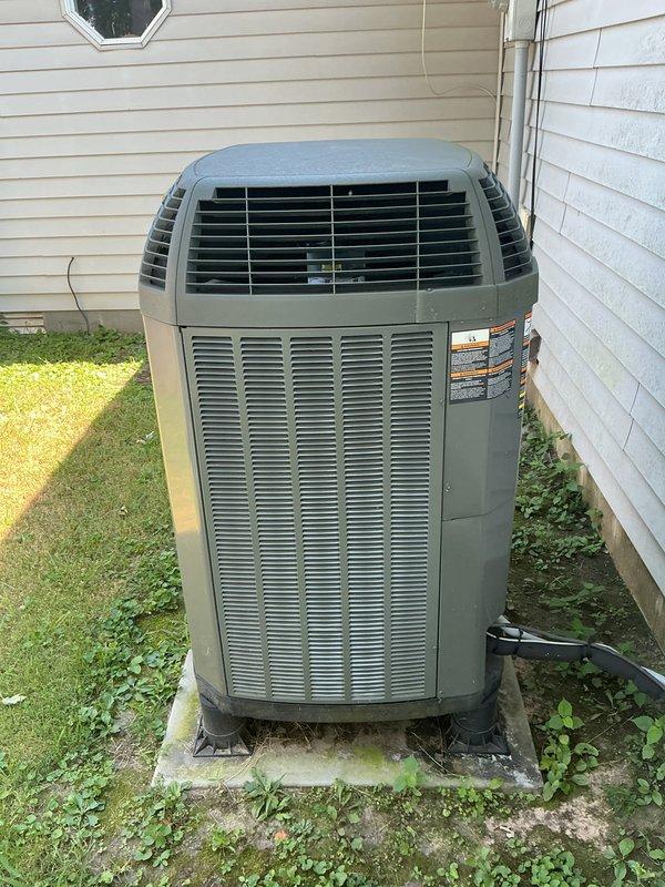 Completed comprehensive cooling maintenance visit including CCC basic monthly service. Installed new 20x20x1 air filter, performed system diagnostics using manifold gauge set to verify refrigerant pressures and overall system performance. Outdoor condenser unit inspected and confirmed operational, though vegetation growth noted around concrete pad perimeter requiring future attention for optimal airflow clearance.