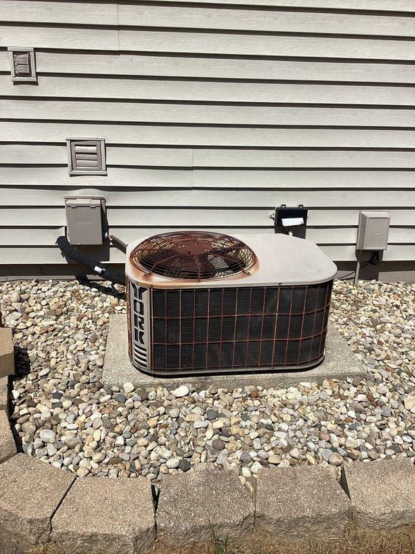 Responded to service call regarding dehumidifier in crawlspace continuing to run. Performed system inspection of outdoor Maytag condenser unit and verified proper operation. Documented equipment condition with photos showing condenser unit positioned on concrete pad with proper clearances and crawlspace access panel in ceiling. Unit found operating within normal parameters with no immediate service needs identified.