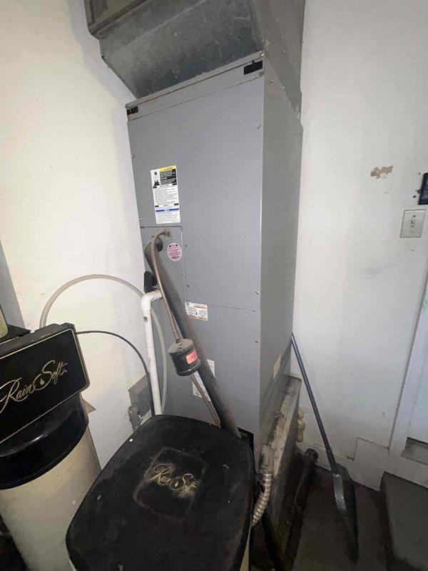Responded to no cooling complaint and performed diagnostic evaluation of split system air conditioning unit. Inspected indoor air handler unit located in utility closet and outdoor condensing unit. Utilized digital multimeter to test electrical components including run capacitor and contactor, obtaining voltage and amperage readings to verify system performance. Identified issue preventing proper operation and documented equipment condition with detailed photographs of electrical components and system configuration.
