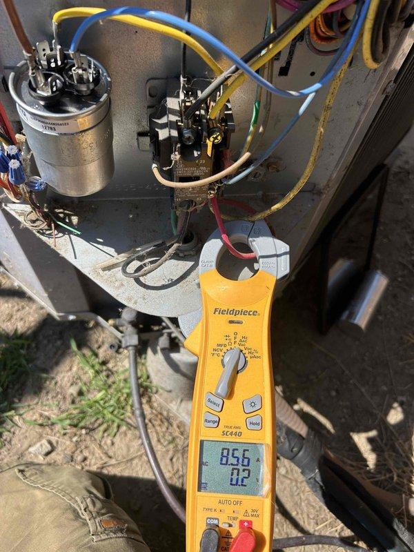 Responded to no cooling complaint and performed diagnostic evaluation of split system air conditioning unit. Inspected indoor air handler unit located in utility closet and outdoor condensing unit. Utilized digital multimeter to test electrical components including run capacitor and contactor, obtaining voltage and amperage readings to verify system performance. Identified issue preventing proper operation and documented equipment condition with detailed photographs of electrical components and system configuration.